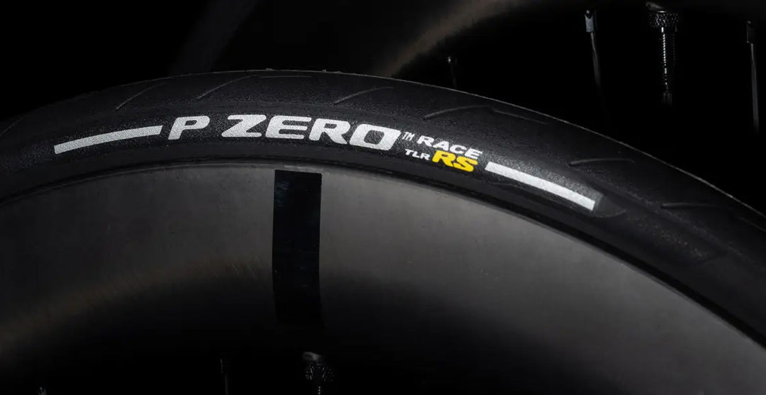 Close-up of a Pirelli P Zero tire with 'P Zero Race' branding on a dark background